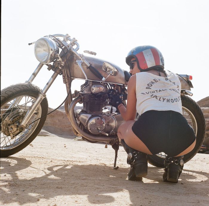 A playful frame from Girls on a motorcycle — online in Amsterdam